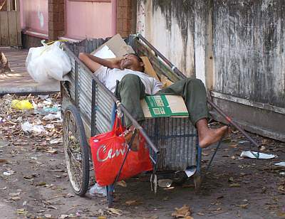 Man sleeping in trash cart